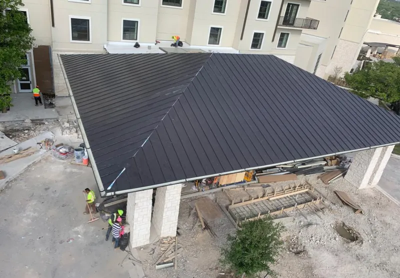 Metal roofing installation team working on a commercial building in Rigby